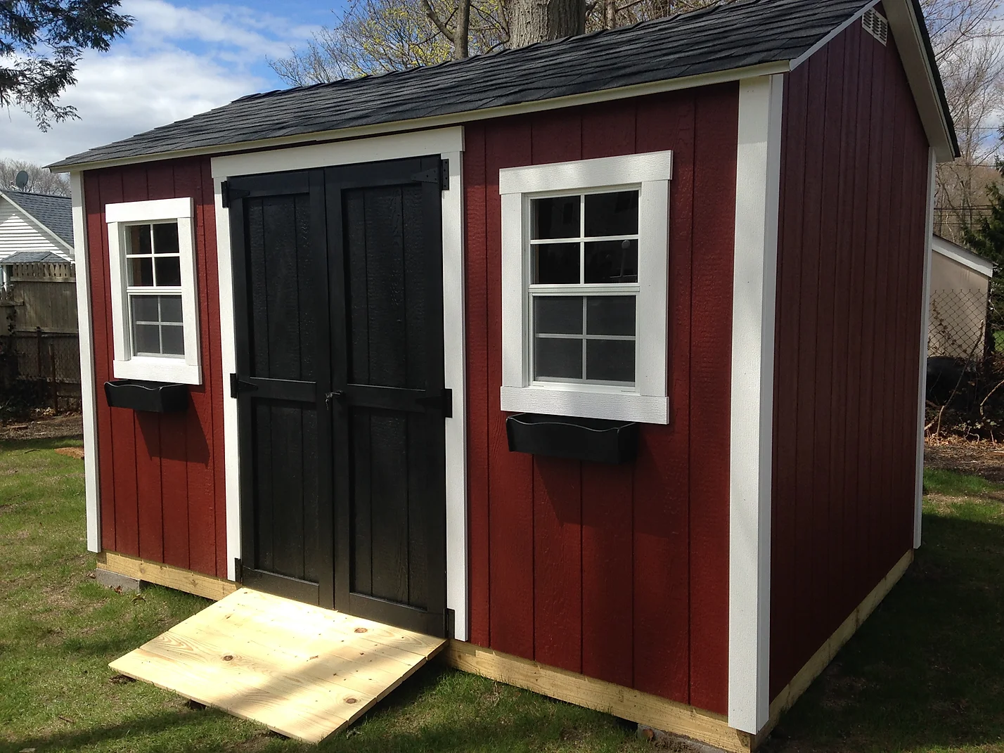 Shed that has been custom painted a deep red color for the customer